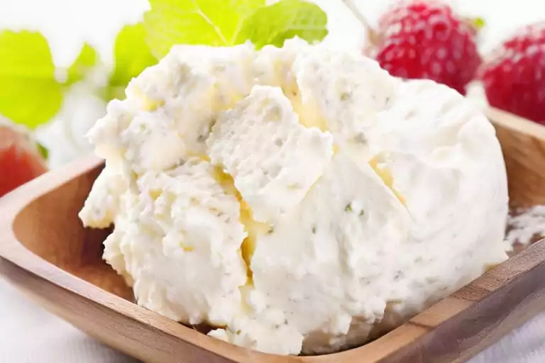 Plate of bagel with fat-free cream cheese and fresh herbs